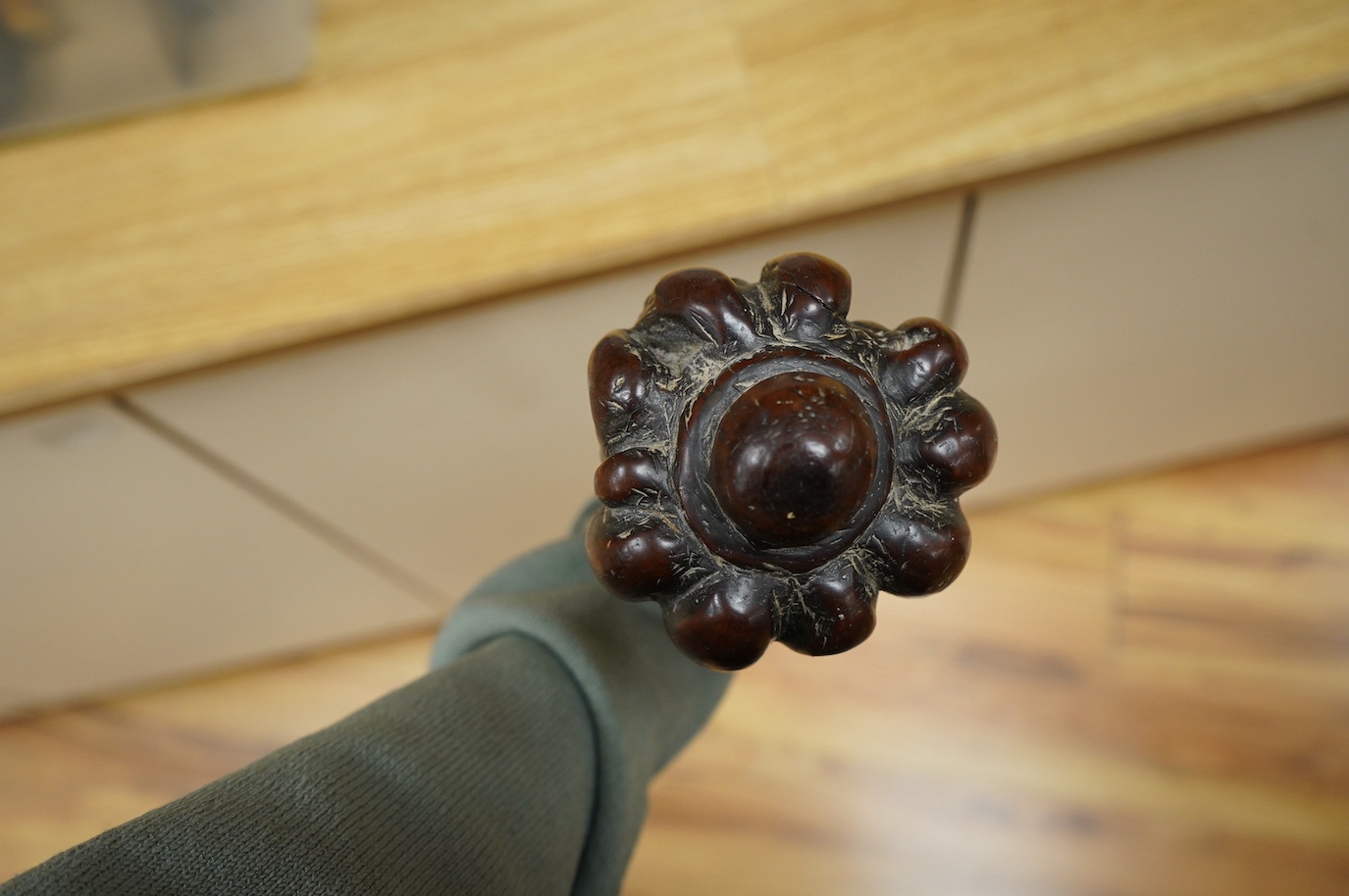 A 19th century Fiji carved hardwood throwing club, Ula, 40cm long, swollen head divided into nine segments, the handle carved with zigzag decoration and incised lines. Condition - good.